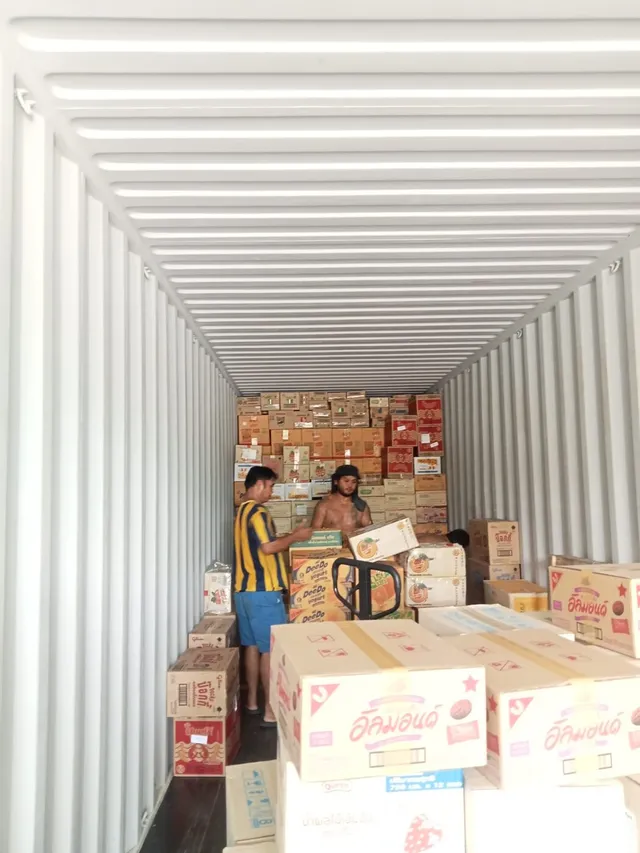 The mixed cargo wall building up carton by carton inside the container.